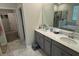 Bathroom features double sinks, gray cabinets and quartz countertop at 5550 Bakewell Pl, St Cloud, FL 34771