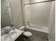 Modern bathroom featuring a vanity sink, toilet, and bathtub with tiled walls at 5550 Bakewell Pl, St Cloud, FL 34771