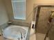 Bathroom features a luxurious soaking tub and separate glass-enclosed shower at 5550 Bakewell Pl, St Cloud, FL 34771