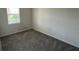 Cozy bedroom features carpeted floors and natural light from the window at 5550 Bakewell Pl, St Cloud, FL 34771