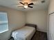 Bedroom featuring a ceiling fan, carpeted floor, closet, and window at 5550 Bakewell Pl, St Cloud, FL 34771