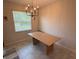 Bright dining area features a large window, tile flooring and an elegant light fixture at 5550 Bakewell Pl, St Cloud, FL 34771