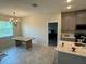 A dining area boasts tile floors, a modern chandelier, and natural light at 5550 Bakewell Pl, St Cloud, FL 34771