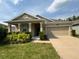 Charming single-story home with a well-manicured lawn and inviting front porch at 5550 Bakewell Pl, St Cloud, FL 34771