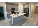 Modern kitchen with gray cabinetry, stainless steel appliances, and center island at 5550 Bakewell Pl, St Cloud, FL 34771
