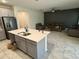 Kitchen island overlooking the open floor plan, features stainless appliances at 5550 Bakewell Pl, St Cloud, FL 34771