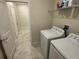 Bright laundry room features tile floors and modern washer and dryer at 5550 Bakewell Pl, St Cloud, FL 34771