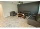 Modern living room with tile floors and neutral gray furniture at 5550 Bakewell Pl, St Cloud, FL 34771