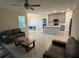 Open-concept living space with a modern kitchen, dining area, and tile flooring at 5550 Bakewell Pl, St Cloud, FL 34771