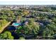 Community aerial view showcasing a pool, lake, and lush greenery at 6021 Windhover Dr # F11, Orlando, FL 32819