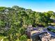 Community aerial view showcasing a pool, lake, and lush greenery at 6021 Windhover Dr # F11, Orlando, FL 32819