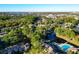 Community aerial view featuring a pool, lake and verdant surrounding landscape at 6021 Windhover Dr # F11, Orlando, FL 32819
