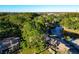 Community aerial view highlighting a pool, lake, and lush surroundings at 6021 Windhover Dr # F11, Orlando, FL 32819