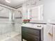 Bathroom showcasing a modern vanity, walk-in shower with decorative tile, and updated fixtures at 6021 Windhover Dr # F11, Orlando, FL 32819