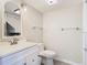 Bathroom featuring a white vanity, tile flooring, and modern light fixture at 6021 Windhover Dr # F11, Orlando, FL 32819