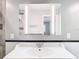 Bathroom with modern lighting, updated vanity, and tiled backsplash at 6021 Windhover Dr # F11, Orlando, FL 32819