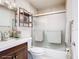 Cozy bathroom featuring a shower and storage shelving at 6021 Windhover Dr # F11, Orlando, FL 32819