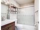 Bathroom includes a shower with glass doors, white tile, and floating shelves at 6021 Windhover Dr # F11, Orlando, FL 32819
