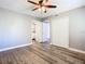 Neutral bedroom featuring wood-look flooring and ample closet space at 6021 Windhover Dr # F11, Orlando, FL 32819