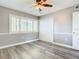 Bedroom with wood flooring, ceiling fan, and natural light from the window at 6021 Windhover Dr # F11, Orlando, FL 32819