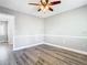 Bedroom with wood flooring, ceiling fan, and neutral paint at 6021 Windhover Dr # F11, Orlando, FL 32819