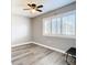 Bedroom featuring wood-look floors, a ceiling fan, and shuttered window at 6021 Windhover Dr # F11, Orlando, FL 32819