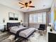 Stylish bedroom with a tufted headboard, unique decor, and ample natural light at 6021 Windhover Dr # F11, Orlando, FL 32819