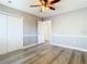 Bedroom with wood flooring, ceiling fan, and neutral paint at 6021 Windhover Dr # F11, Orlando, FL 32819