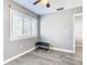 Bright bedroom features wood-look floors and plantation shutters on the window at 6021 Windhover Dr # F11, Orlando, FL 32819