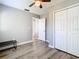 This bedroom features a large closet, wood-look flooring, and neutral paint at 6021 Windhover Dr # F11, Orlando, FL 32819