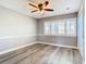 Bedroom with wood flooring, ceiling fan, and natural light from the window at 6021 Windhover Dr # F11, Orlando, FL 32819