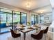 Dining room features a large table with mirrored wall reflecting open living space at 6021 Windhover Dr # F11, Orlando, FL 32819