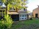 Charming home exterior featuring screened porch and shuttered windows at 6021 Windhover Dr # F11, Orlando, FL 32819