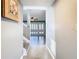 Bright foyer featuring tile floors, staircase, and view into the living room with stylish shutters at 6021 Windhover Dr # F11, Orlando, FL 32819