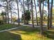 Scenic view of the landscaped grounds, featuring a pond and walking path at 6021 Windhover Dr # F11, Orlando, FL 32819