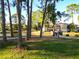 Scenic view of community with mature trees, pond, and bridge at 6021 Windhover Dr # F11, Orlando, FL 32819