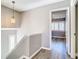 Hallway with neutral walls, wood-look floors, and view to bedroom with shuttered windows at 6021 Windhover Dr # F11, Orlando, FL 32819