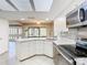 Kitchen featuring white cabinets, stainless appliances and granite countertops at 6021 Windhover Dr # F11, Orlando, FL 32819