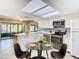 Well-lit kitchen featuring modern appliances, countertops, and an adjacent dining area at 6021 Windhover Dr # F11, Orlando, FL 32819