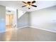 Living room featuring tiled floors, ceiling fan and staircase at 6021 Windhover Dr # F11, Orlando, FL 32819