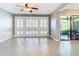 Open living room showcasing tiled floors and large windows at 6021 Windhover Dr # F11, Orlando, FL 32819