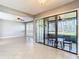 Open living room with sliding glass doors to lanai and access to the kitchen at 6021 Windhover Dr # F11, Orlando, FL 32819