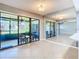 Bright living room with sliding glass doors to the screened lanai at 6021 Windhover Dr # F11, Orlando, FL 32819