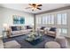 Stylish living room with large windows, shutters, and comfortable seating at 6021 Windhover Dr # F11, Orlando, FL 32819