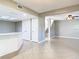 Open floor plan showcasing tiled flooring, access to the stairs, and neutral paint at 6021 Windhover Dr # F11, Orlando, FL 32819