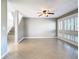 Open living room area showing tiled floors and stairway at 6021 Windhover Dr # F11, Orlando, FL 32819