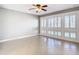 Sun-filled living room featuring tiled floors and many windows with shutters at 6021 Windhover Dr # F11, Orlando, FL 32819
