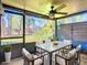 Inviting screened porch with dining table and chairs at 6021 Windhover Dr # F11, Orlando, FL 32819