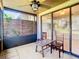 View of screened-in porch with ceiling fan and a view of the backyard at 6021 Windhover Dr # F11, Orlando, FL 32819