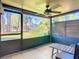 View of screened-in porch with ceiling fan and a view of the community at 6021 Windhover Dr # F11, Orlando, FL 32819